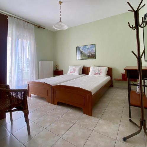 a bedroom with a large bed in a room at Apartments Thomoglou in Keramoti