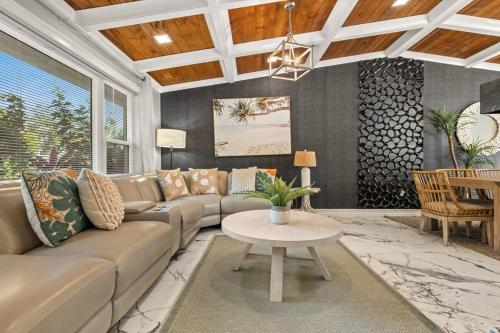 a living room with a couch and a table at Serenity Haven Luxe Pet Friendly 5BR With Pool in Clearwater