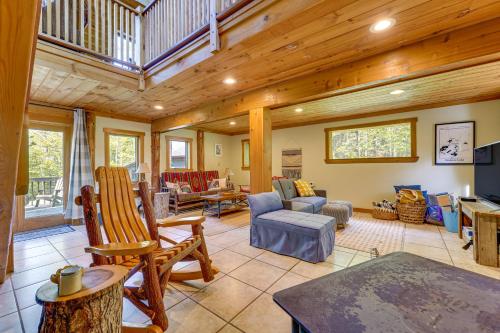 a large living room with a wooden ceiling at Saranac Lake Cabin with Deck Pets Welcome! in Saranac Lake