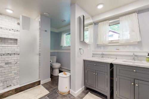 a bathroom with two sinks and a toilet at Fox Lane Retreat in White River Junction