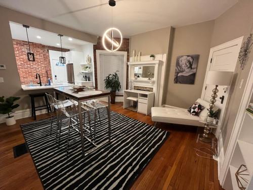 a living room with a table and a dining room at 2 BR Totally Renovated and Chic in Columbus