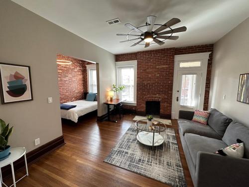 a living room with a couch and a table at Big Brick 2 Bedroom apartment in Victorian Village in Columbus