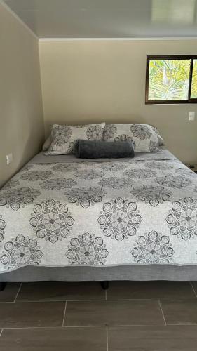 a bed in a bedroom with a bedspread on it at Nani House in Montezuma