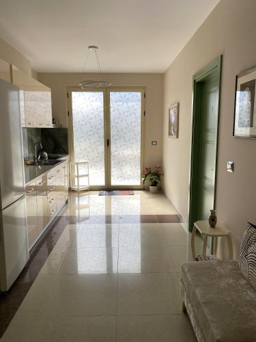 a large living room with a large glass door at Tinas Rooms in Durrës