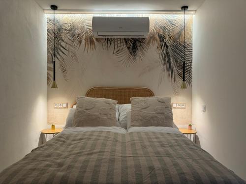 a bedroom with a bed with a tv on the wall at Bánhiday H31 Beach house in Balatonakarattya