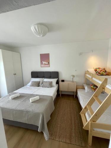 a bedroom with two beds and a ladder in it at Apartments Ula in Vodice