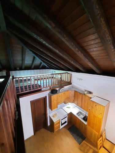 an overhead view of a kitchen with wooden cabinets at Chapel`s House in Pteleós