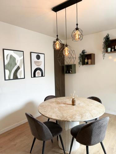 - une salle à manger avec une table et des chaises en marbre dans l'établissement Charmante Maison indépendante T3, à Suresnes