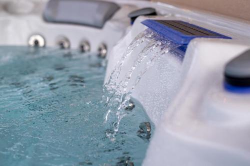a bath tub with water pouring out of it at ONAR - LUXURY VILLAS in Argostoli