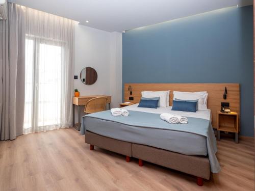 Postel nebo postele na pokoji v ubytování Athinaiko Hotel