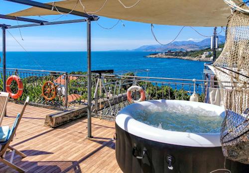a hot tub on a deck with a view of the ocean at Apartment Carpe Diem with the best sea view, Utjeha Montenegro Mediterranean Eu in Masline
