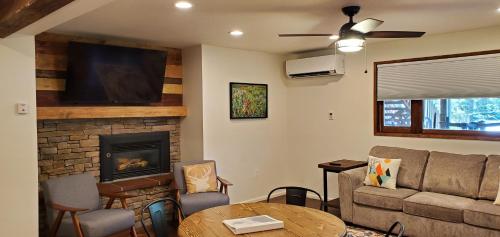 a living room with a couch and a fireplace at Eagle Cap Chalets in Joseph