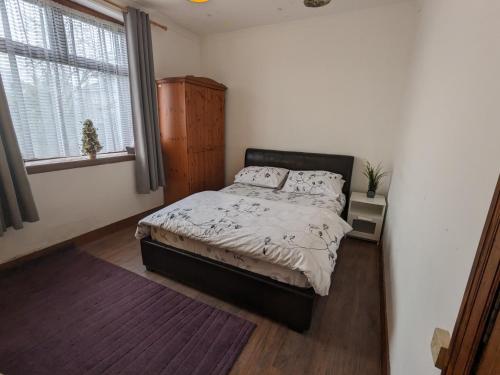 a bedroom with a bed and a window at House of Bondol in Aberdeen