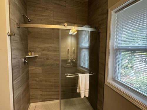 a bathroom with a shower with a glass door at River Hotel of Southport in Southport