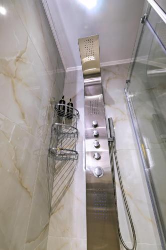 a shower with a glass door in a bathroom at Gaia Suite in Nafplio