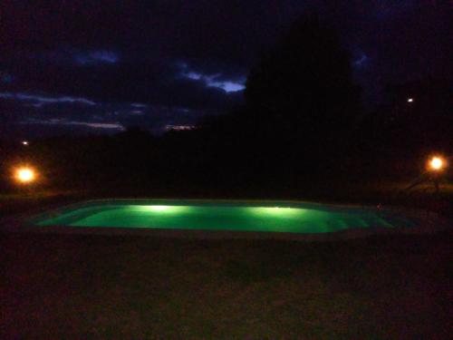 a small pool of green illumination at night at Hotel El Refugio nudista naturista opcional in Chihuahua
