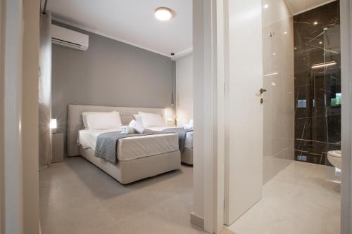 a bedroom with a bed and a bathroom with a shower at ONAR - LUXURY VILLAS in Argostoli