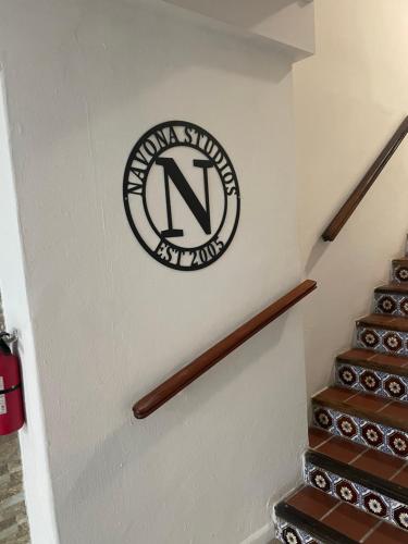a sign on the wall of a stairway with stairs at Navona Studios in San Juan