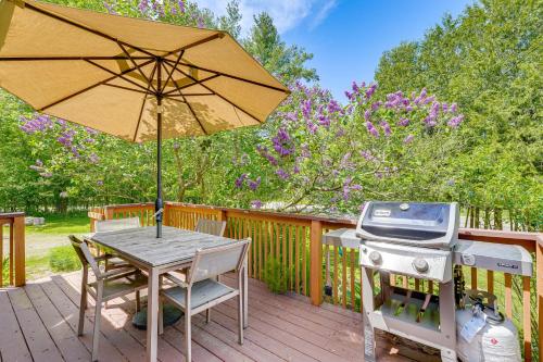 a grill and a table with an umbrella on a deck at Pet-Friendly Wilmington Retreat with Hot Tub! in Wilmington