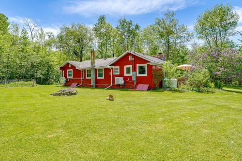 a red house in a yard with a yard at Pet-Friendly Wilmington Retreat with Hot Tub! in Wilmington