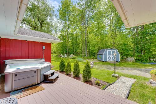 a backyard with a grill and a red house at Pet-Friendly Wilmington Retreat with Hot Tub! in Wilmington