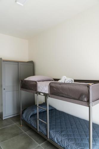 a bunk bed in the corner of a room at IsabellApartments in Canelli