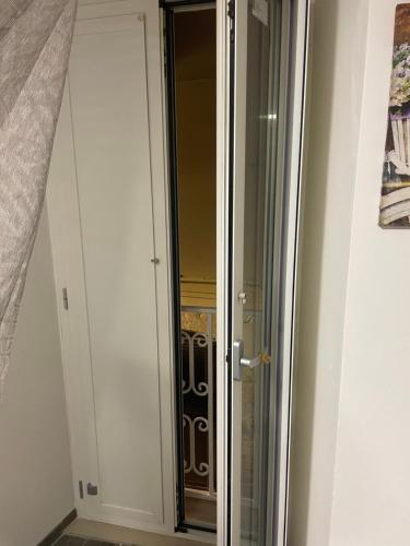 a closet with a glass door in a room at La Stradina in Barletta