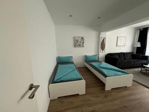 a room with two beds and a living room at Zentrale, stilvolle Wohnung in Lübeck