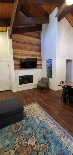 a living room with a fireplace and a tv at Eagle Cap Chalets in Joseph
