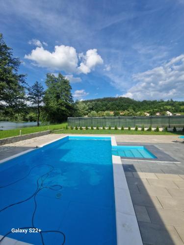 uma piscina azul com vista para a água em Eurouna relax em Bosanska Krupa
