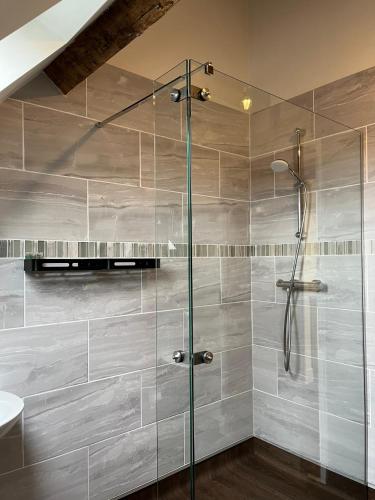 a shower with a glass door in a bathroom at Yew Tree Farm in Atherstone