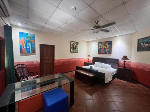 a bedroom with a bed and a ceiling fan at Casa Manglar Villa in Puerto Jiménez