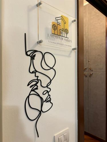 a wall with a drawing of a face on it at LA CASA DI AMBRA in Limbiate