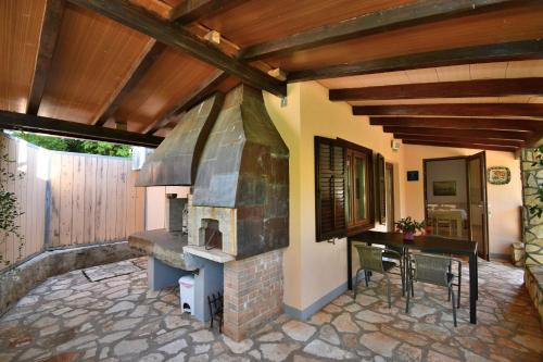 a patio with an outdoor oven and a table at House Ariella in Umag