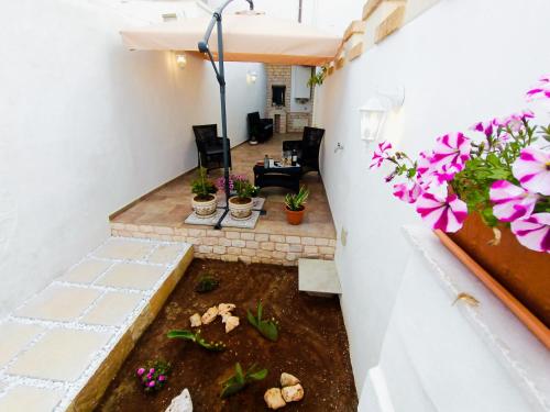 a view from the balcony of a house with flowers at La Carosa Suite in Oria