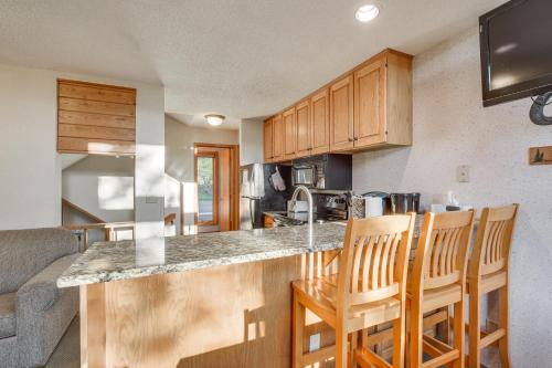 a kitchen with a counter and some wooden cabinets at Cozy Alpine Escape Ski-InandOut at Lutsen Mtns in Lutsen