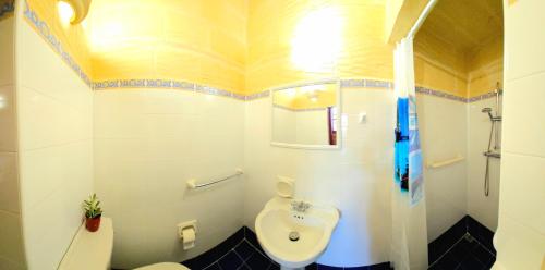 a bathroom with a toilet and a sink at Traditional Farmhouse Central Gozo in Xagħra