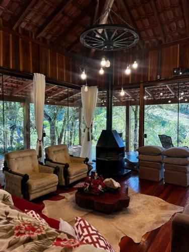 a living room with a fireplace in a house at Chalé Da Pecan in Anta Gorda