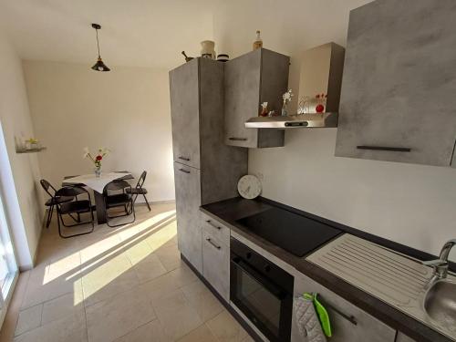 a small kitchen with a table in the background at Casa Daniel in Selva di Fasano