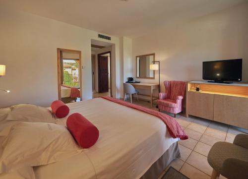a hotel room with a bed and a television at Hotel Ca'l Bisbe in Sóller