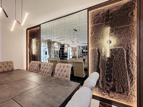 a dining room with a table and chairs at ELAN RIMAL SADAF Suites in Dubai