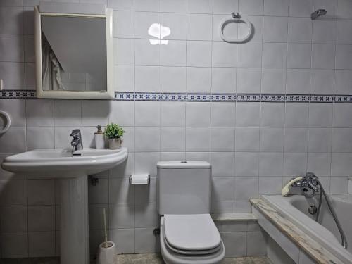 a bathroom with a toilet and a sink and a tub at Villa Papona - Ático ,parking in Moaña