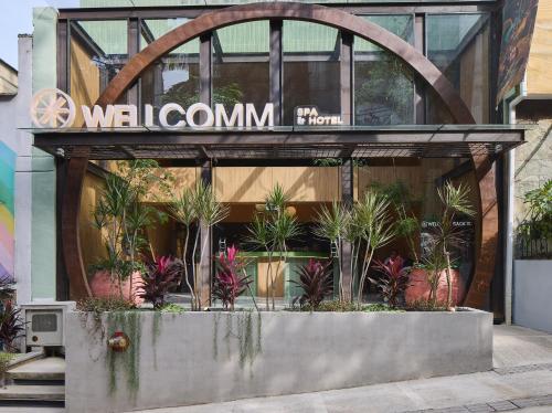 Wellcomm Spa & Hotel في ميديلين: محل امام مبنى يوجد به نباتات
