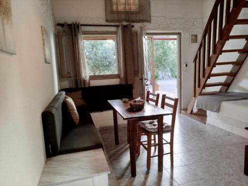 a living room with a table and a couch at Almmos Mezzanine Apartments 2 in Kalamaki Heraklion