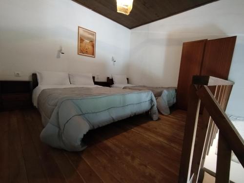 a hotel room with two beds and a staircase at Almmos Mezzanine Apartments 2 in Kalamaki Heraklion