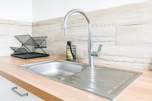 a stainless steel sink in a kitchen at Pilepoal II - Balcon - Parking - 6Pers - Lumineux in Villemomble