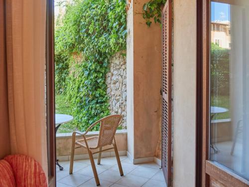 a room with a chair and a table and a window at Hotel Ca'l Bisbe in Sóller