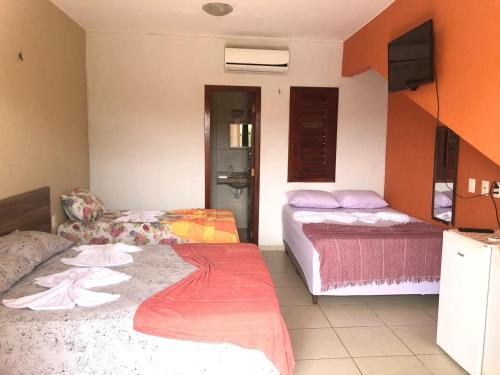 Uma cama ou camas num quarto em Pousada Vila do Pôr do Sol Canoa Quebrada