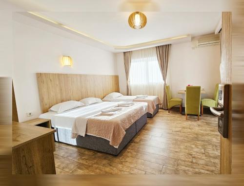 a hotel room with two beds and a television at Villa Montemaris Budva in Budva