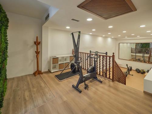 a room with a gym with exercise equipment in it at Hotel Ca'l Bisbe in Sóller